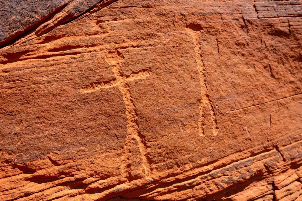 Petroglyphs carved in orange stone 