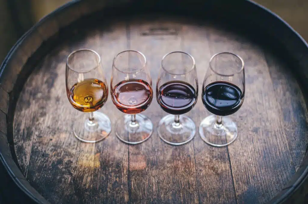 Four glasses of wine for a wine tasting on a barrell 
