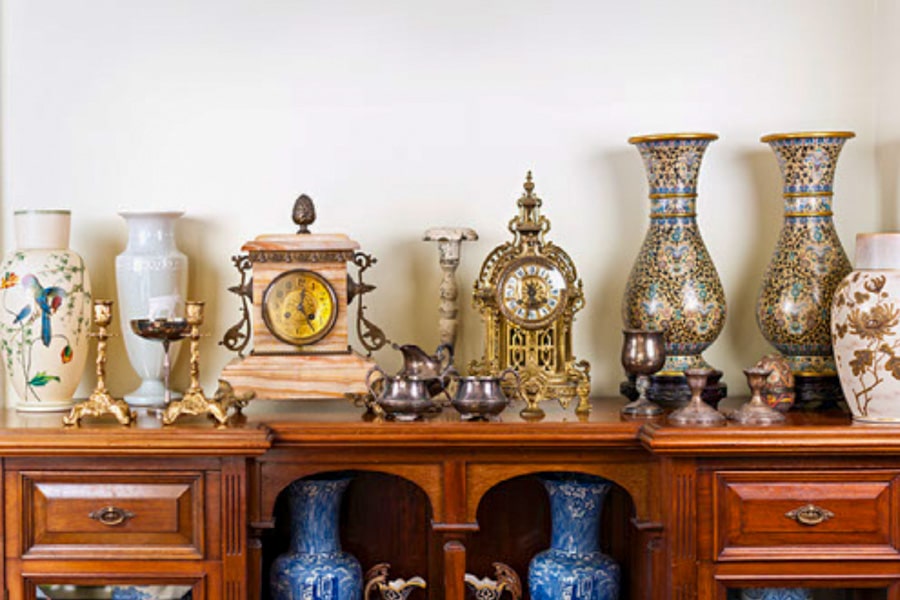 Antiques and clocks on a dresser 