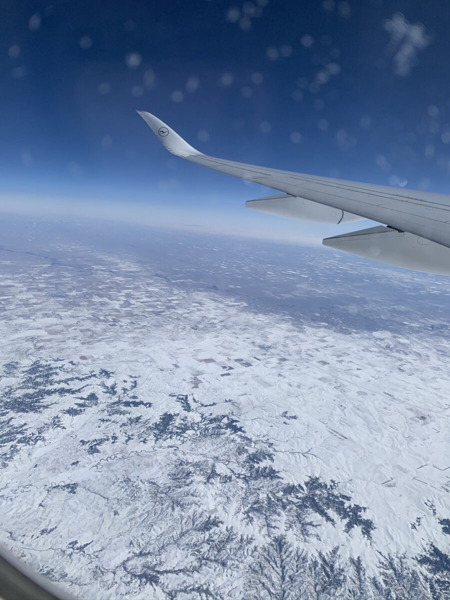airplane view over snowy mountains