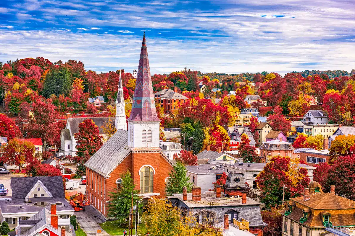 church and city in new england with fall foliage in the fall months in the usa 